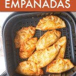 SEVERAL EMPANADAS IN AN AIR FRYER BASKET