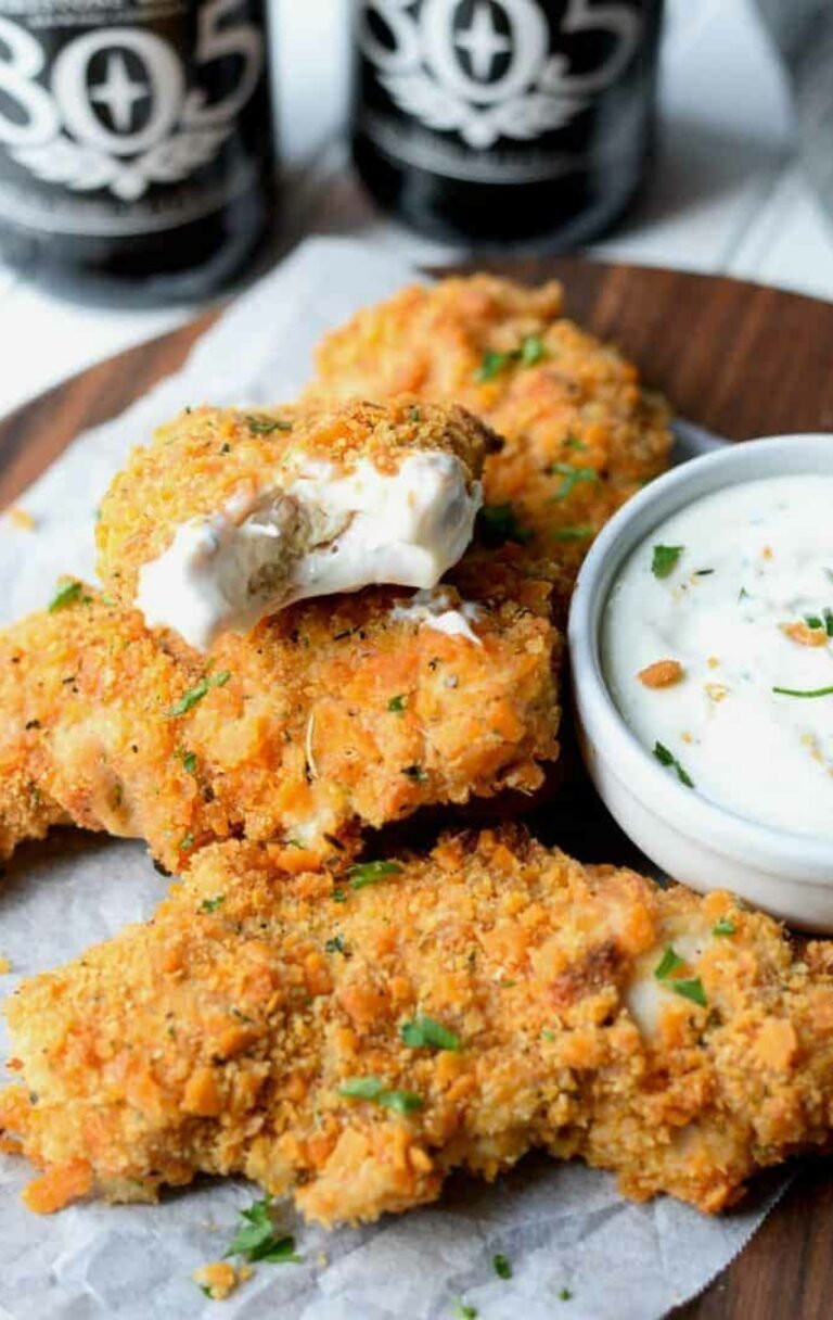 Cheez-It Chicken Tenders on a wooden chopping board.