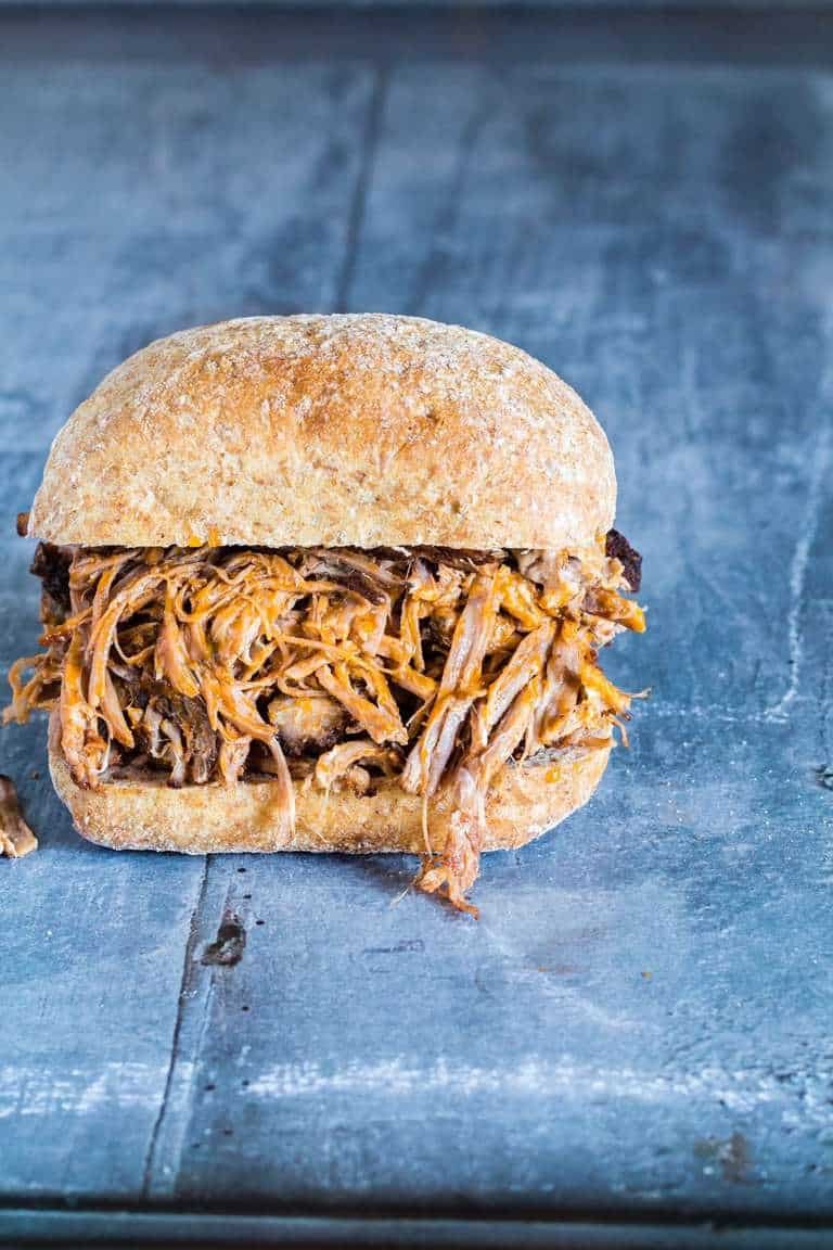 A simple dutch oven pulled pork sandwich bun on a table