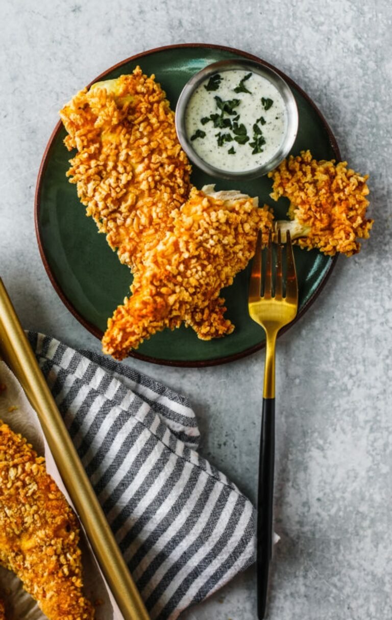 Pickle Brined Air Fryer Chicken Tenders in a green plate with gold fork.