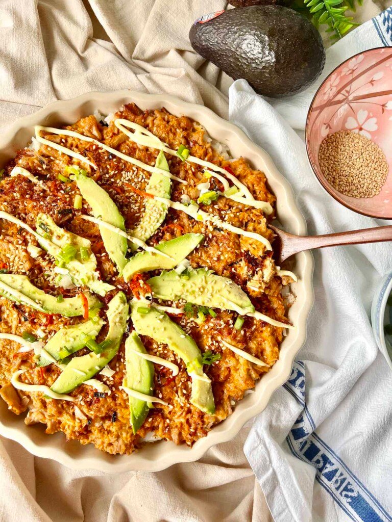 Sushi Bake in a casserole dish with a serving spoon.