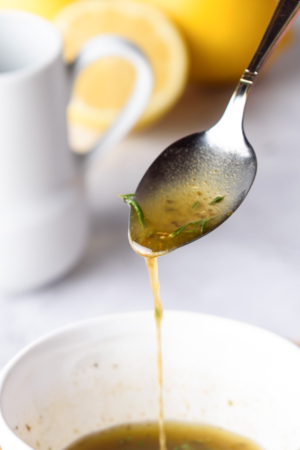 a spoon pouring turkey marinade into a bowl