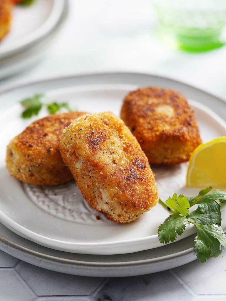 Tuna Croquettes on a white plate with garnish.