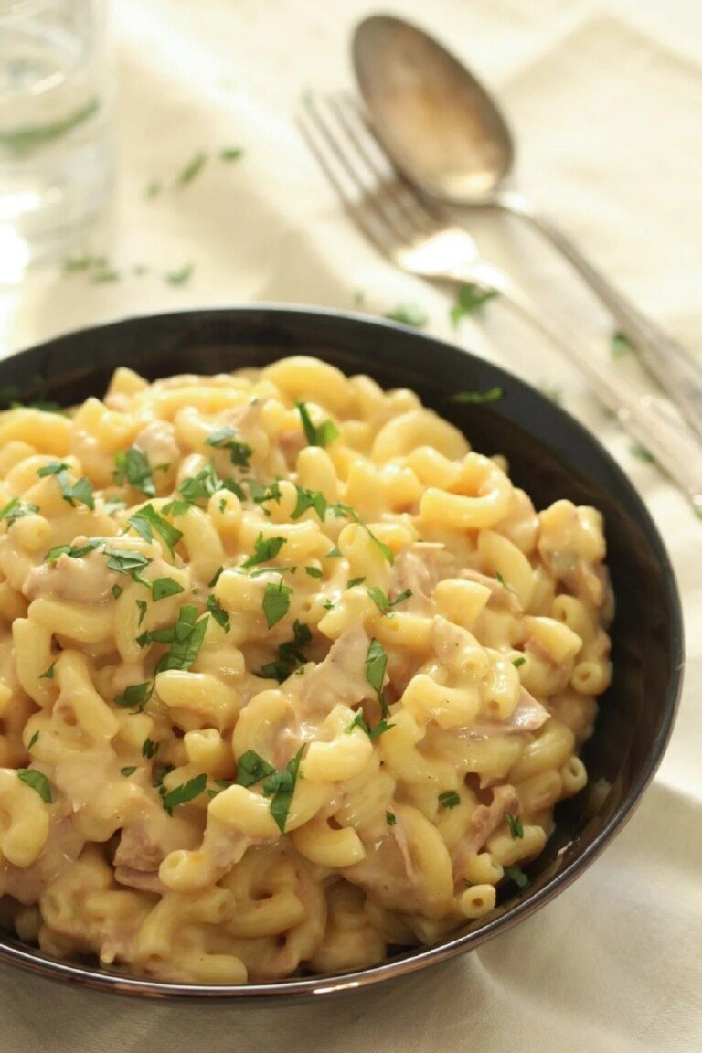 Tuna Mac and Cheese in a black plate with garnish.