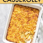 A corn casserole in a casserole dish with a spoon in it.