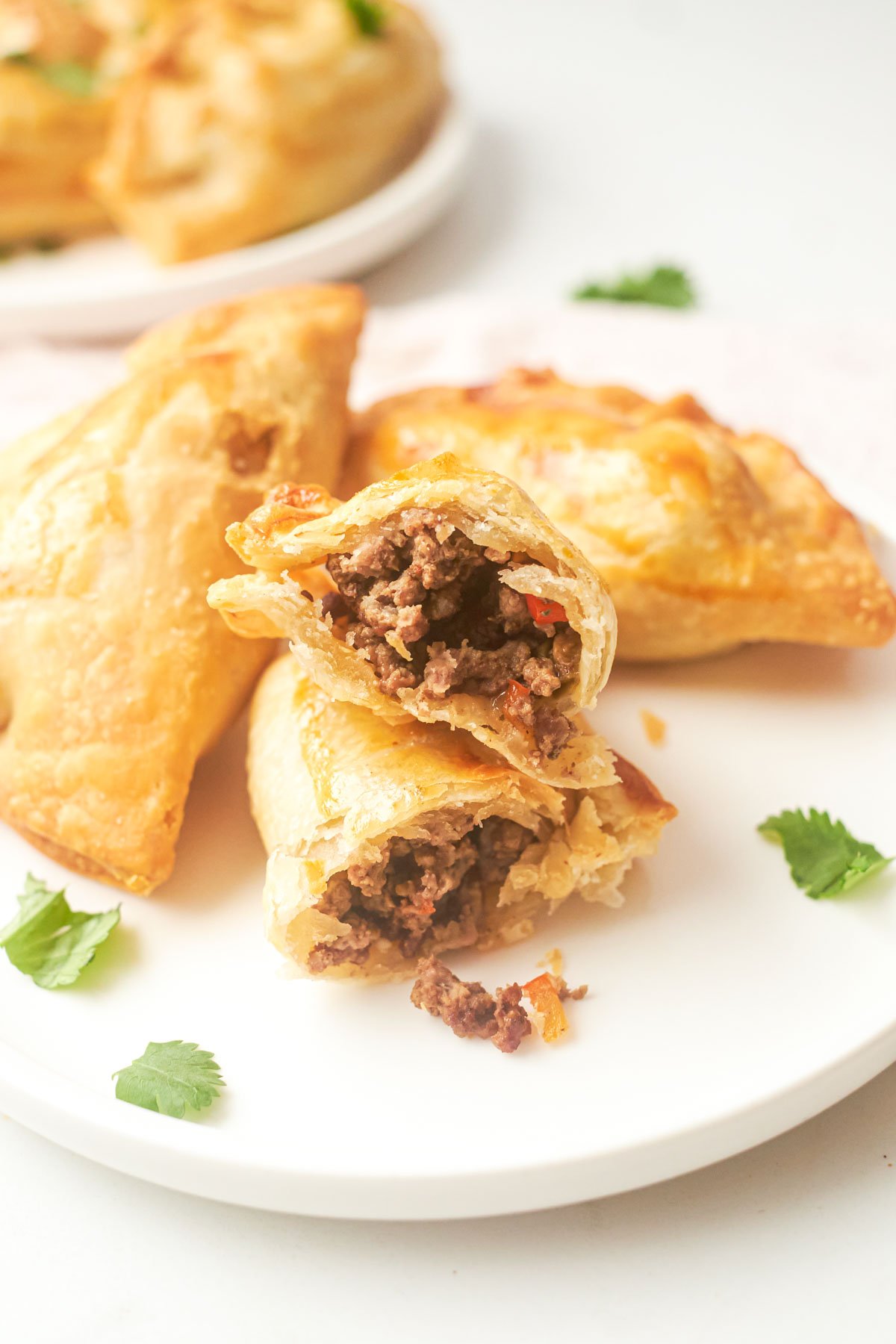 three completed air fryer empanadas served on a white plate