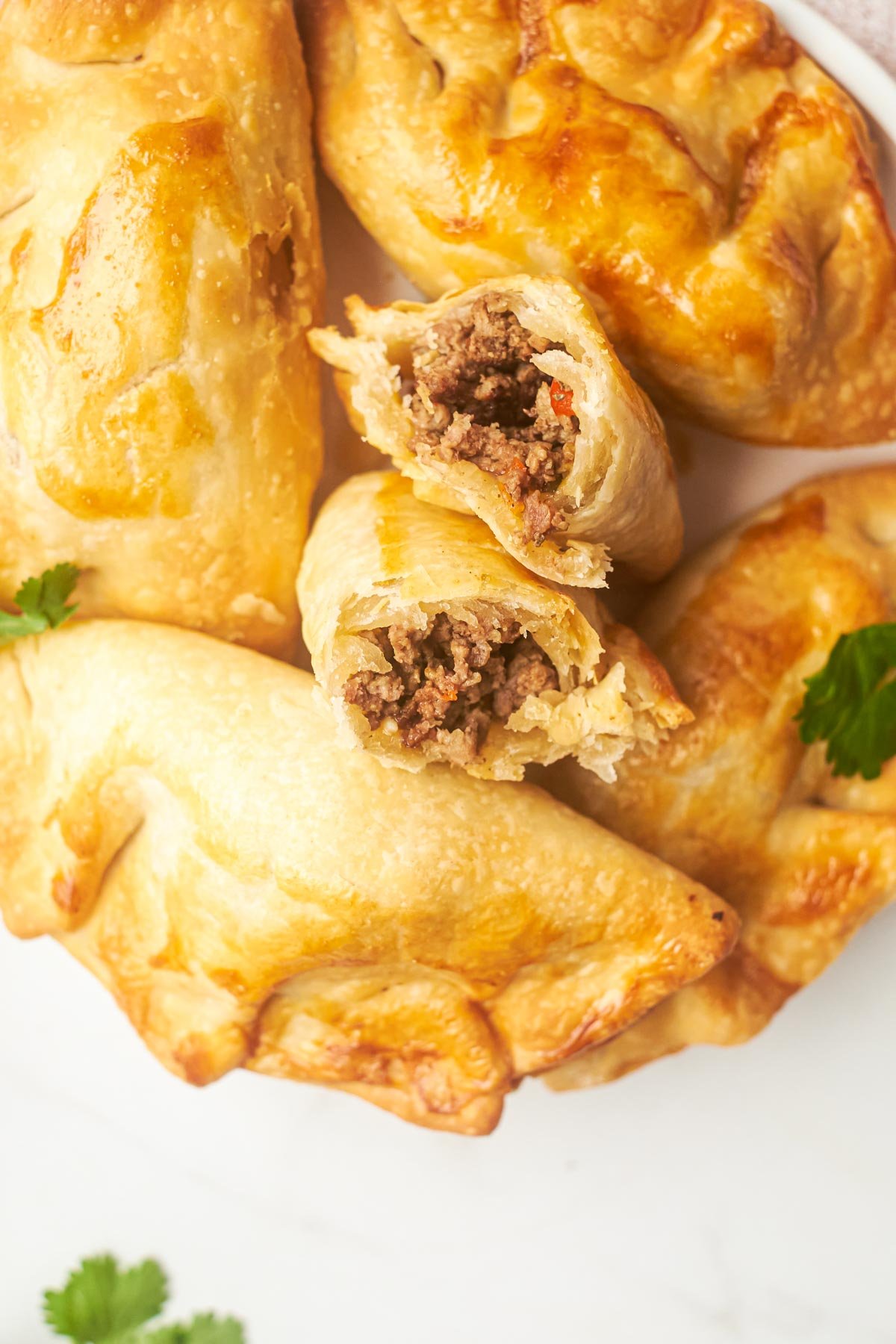 close up view of a plate filled with air fryer empanadas