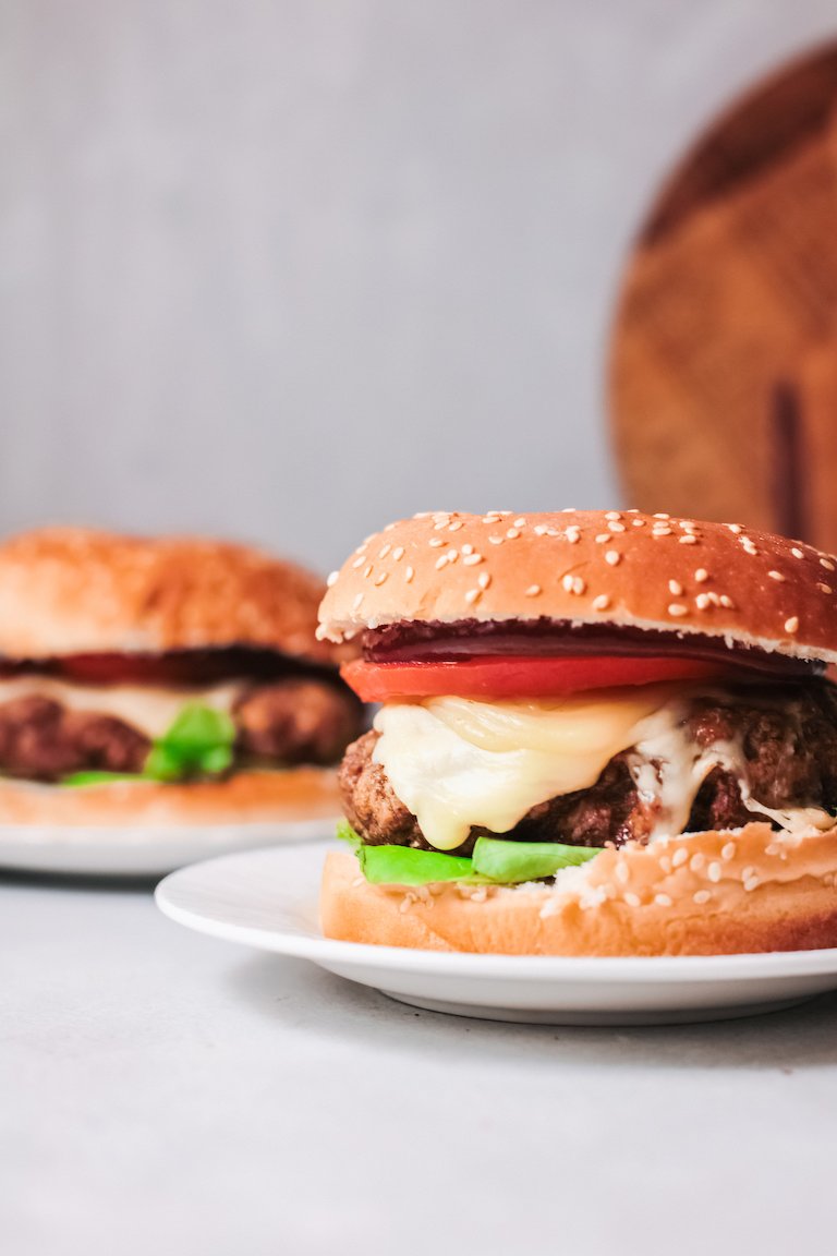 two of the completed turkey burgers served on sesame seed buns