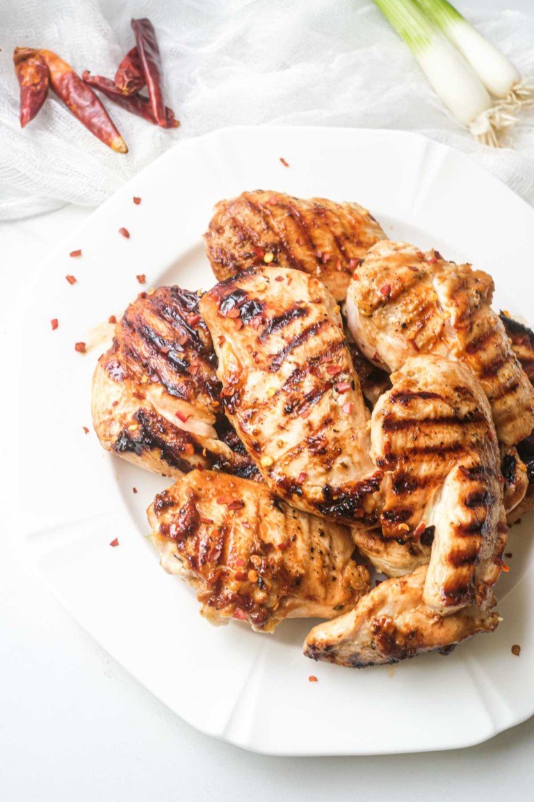 the finished grilled chicken tenders on a white plate ready to serve