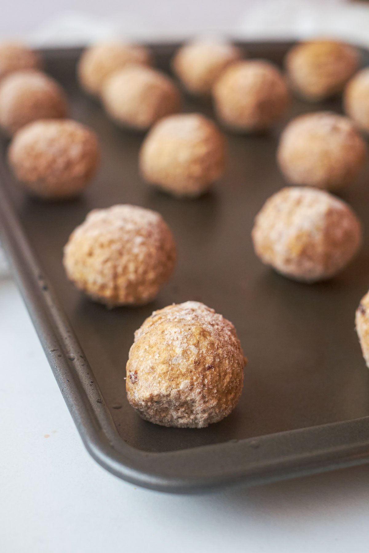 close up view of how to cook frozen meatballs in oven on a baking sheet