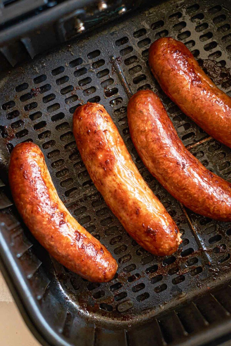 close up view of cooked Italian sausage in the air fryer basket