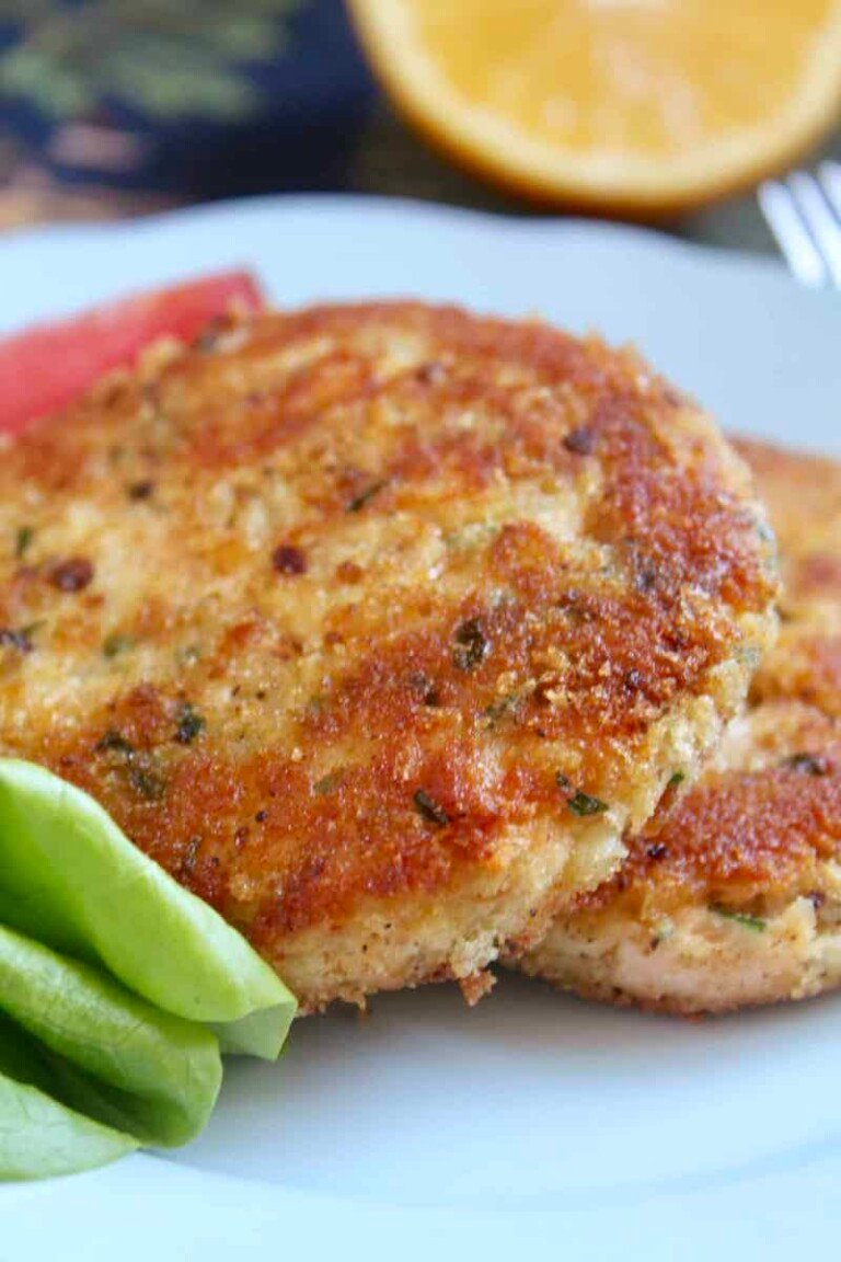 two potato and salmon fish cakes on a plate