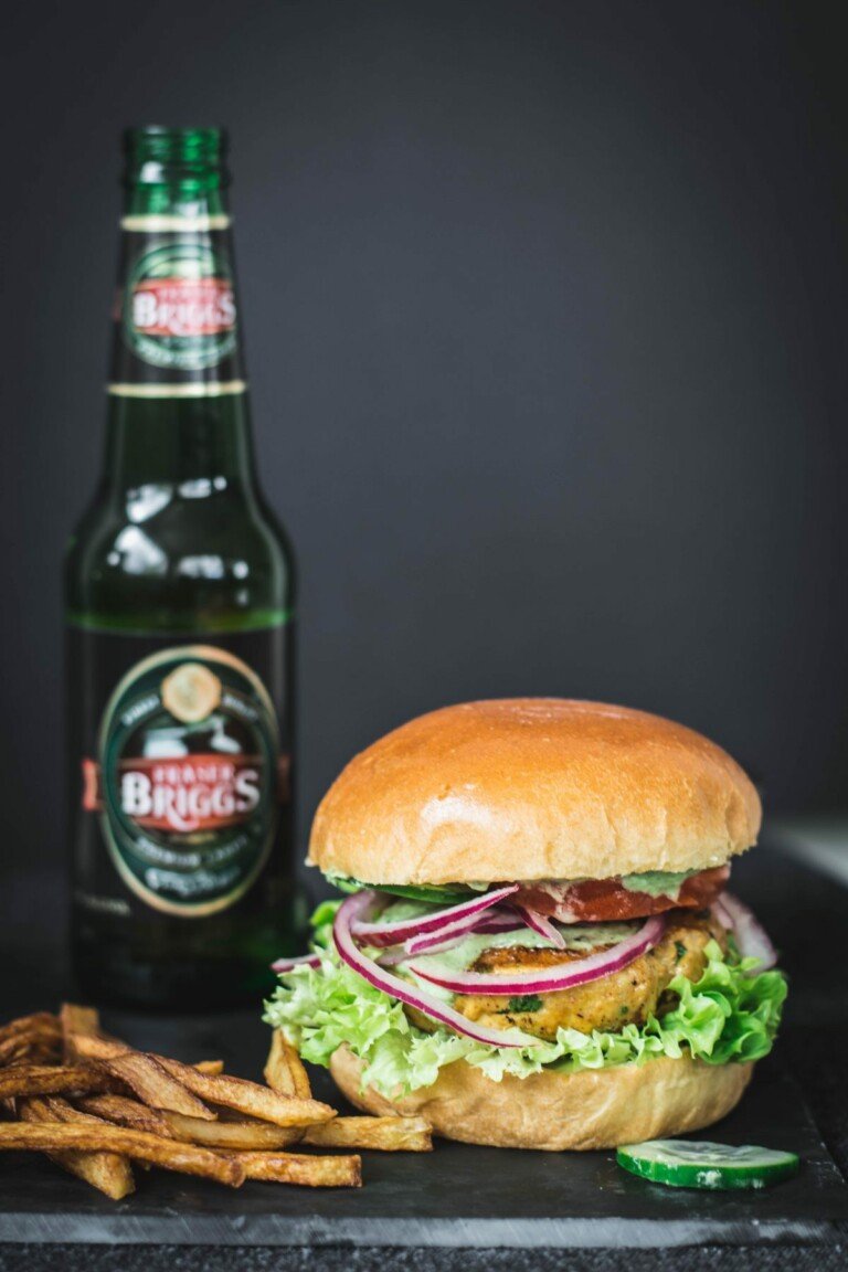 one tandoori chicken burger with fries and a beer